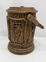 Full view of faux wood grape relief ice bucket with lid and handle visible
