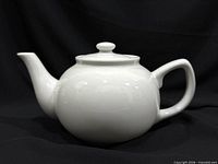 Full side view of teapot with lid on