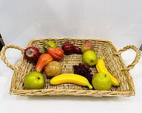 Top view of the wicker rattan serving tray with decorative fruit inside for scale