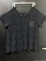 Front view of polka dot t-shirt on hanger