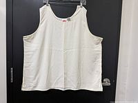 Front view of ivory sleeveless tank top hanging