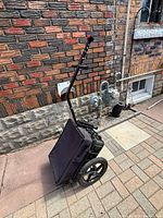 Cart folded upright showing handle and wheel