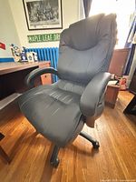 Front perspective of black faux leather high-back office chair