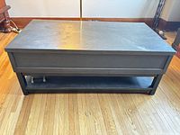 Front view of rectangular black coffee table showing lower shelf
