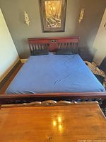 Full view of king bed frame with mattress and footboard visible
