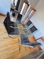 Entire dining set showing glass table and six chairs