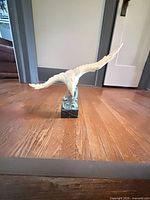 Front view of seagull sculpture on base