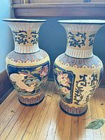 Front view of both porcelain vases showing motifs and colors