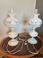 Both hurricane lamps on table showing overall design