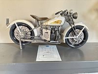 Left side view of 1934 Indian Sport Scout model with COA displayed