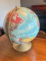 North America, Atlantic and Arctic regions shown on globe, gold metal base visible