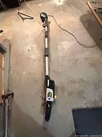 Full length view of Yardworks pole saw extended on floor