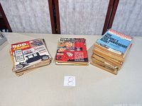 Three stacks of assorted 1960s automotive magazines, lot reference card visible