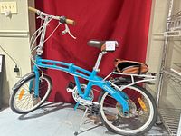 Left side full view of bicycle with rack, fenders, saddle bag