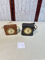 Front view of both clocks side by side