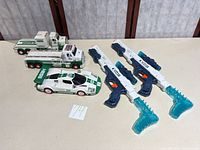 Overall lot showing Hess vehicles and two X-Shot blasters