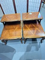 Top view of both matching Bassett step end tables showing veneer pattern and two-tier design
