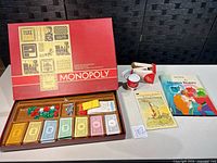 Open Monopoly set with accessories, Li'l Washer and book