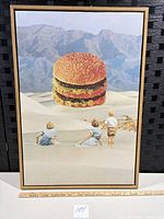 Front view of framed surreal hamburger desert canvas art with ruler for scale