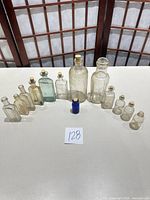 All 13 bottles in semicircle showing colors, corks, sizes