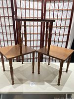 Three brown plant stands displayed together