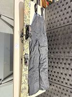 Full view of skis with bindings and Arctix bib pants laid out