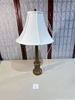 Full view of brass table lamp with white fabric shade showing overall condition and design