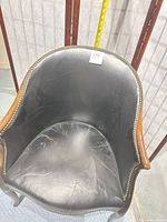 Top view of chair seat and back showing leather wear and nailhead detail