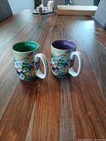 Both personalized Disneyland mugs front view on tabletop