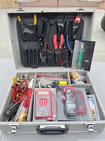 Open case showing organized hand tools, meters, small parts