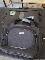 Gamma and SwissGear style briefcases on table