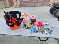 Overall view of bucket organizer with tools and hardware laid out on table