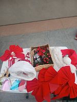 Group view of bows, basket with picks, hat, headband, mitten ornaments