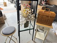 Group shot showing stool, metal-glass stand, floral vase, wicker basket, side table