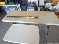 Large and small Lifetime folding tables with two telescoping rods on top