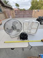 All three fans side by side on tables