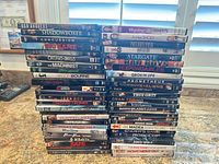 Four stacks of DVD cases showing spine titles and quantity