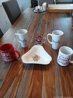 Group shot of all mugs, dish and shot glass