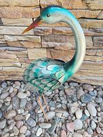 Teal patina metal flamingo showing head, body, stake legs