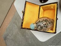 inside-painted snuff bottle in open fabric-lined box