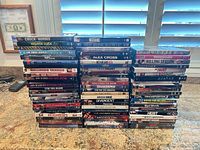 Four vertical stacks of DVD and Blu-ray cases showing spine titles