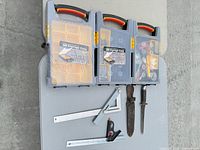 Overall lot view: three storage cases, squares, knives