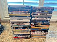 Two vertical stacks of DVD and Blu-ray spines showing variety and quantity