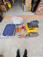 Group shot of all towing accessories, toolboxes, tote, moving blanket and straps