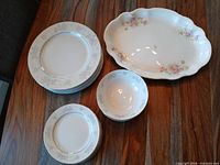 Group view of dinner plates, salad plates, bowl and scalloped oval serving platter