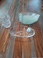 Pitcher, stacked bowls, and oval dish on wooden table