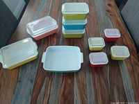 Group shot of all colored glass dishes and lids on table