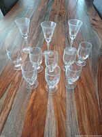 Full set of 11 glasses on table arranged by height