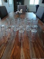 All 14 clear glass tumblers arranged on table showing three pattern types