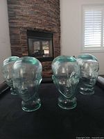 Four glass mannequin heads front view